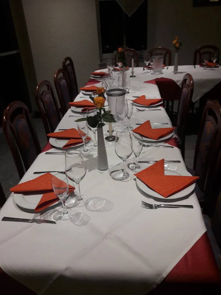 Festlich eingedeckte Tafel mit orangefarbenen Servietten im La Mamma Mia